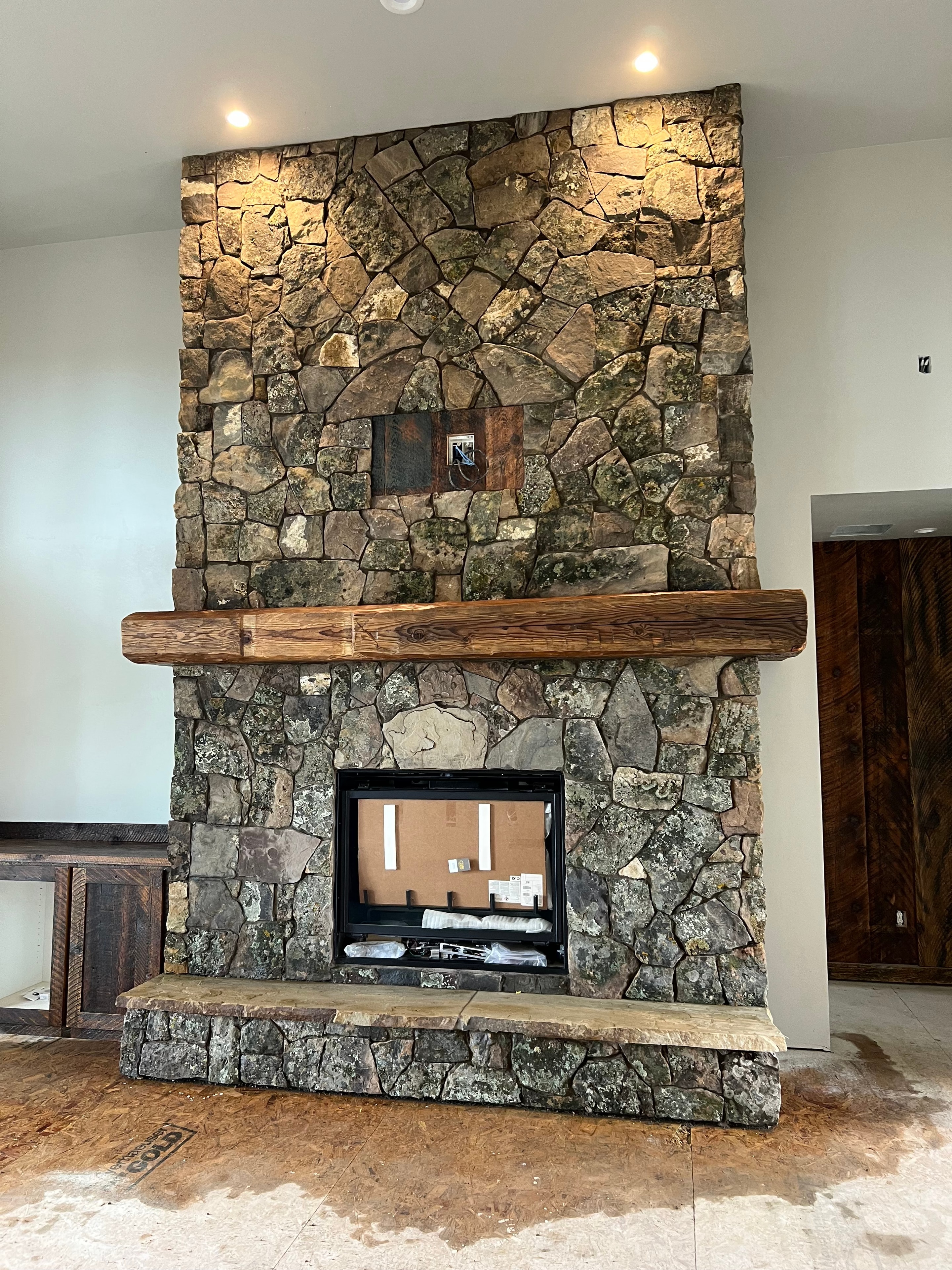 Fieldstone Fireplace with Beam Mantel